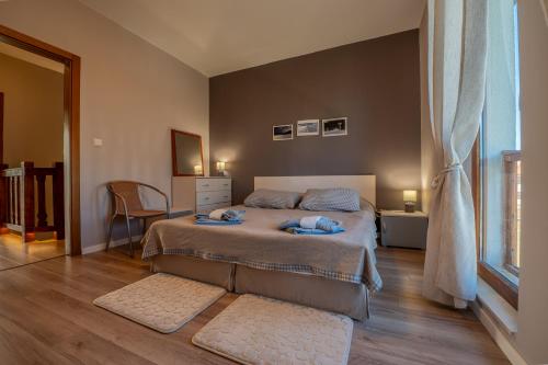 a bedroom with two beds and a window at Къща за гости В 12 и 5 in Dolna Banya