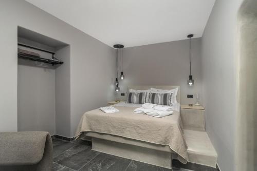 a bedroom with a bed with two towels on it at Uncle's House Junior Suite INDOOR Pool in Adamantas