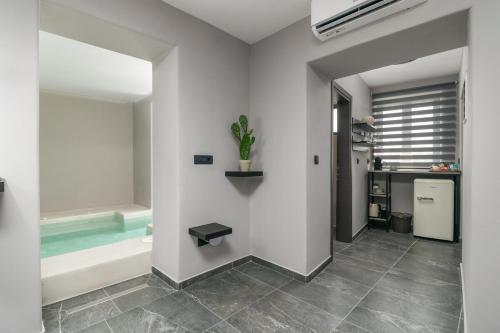 a bathroom with a tub and a sink at Uncle's House Junior Suite INDOOR Pool in Adamantas