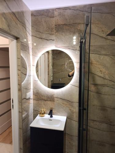 a bathroom with a sink and a mirror at Perła Residence in Kutno