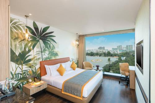 a hotel room with a bed and a large window at Plume Hotels, India Expo Mart, Greater Noida in Greater Noida