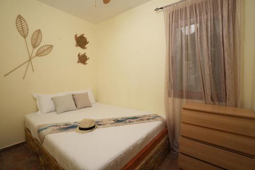 a small bedroom with a bed and a window at Golden Beach, Gerakini in Gerakini