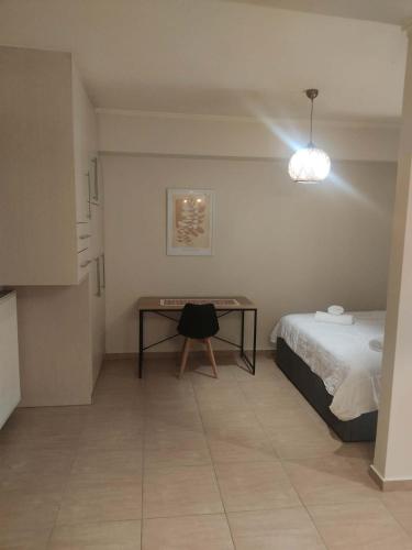a bedroom with a bed and a table in it at Super central studio apartment in Kalavrita