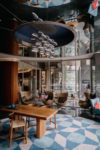 a lobby with a wooden table and chairs at Renaissance Izmir Hotel in İzmir