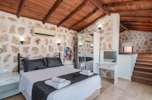 a bedroom with a bed and a tv in a room at Villa Elvin in Kalkan