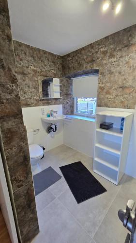 a bathroom with a toilet and a sink at Ferienhaus check ferien dot world in Berenbach
