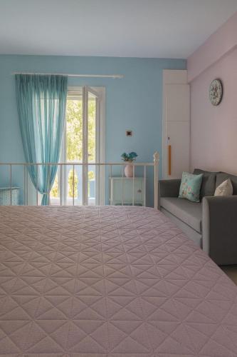 a large bed in a room with a couch at Colorful House Tsoutsouras in Tsoutsouros