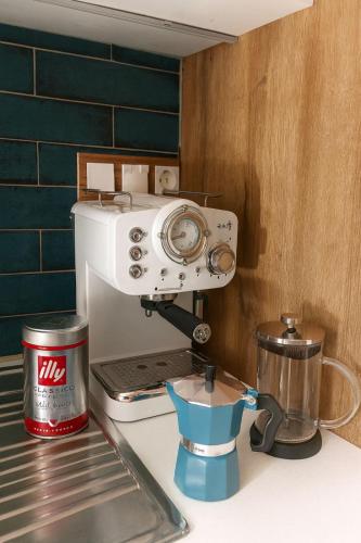 a kitchen counter with a coffee maker and a mixer at Colorful House Tsoutsouras in Tsoutsouros