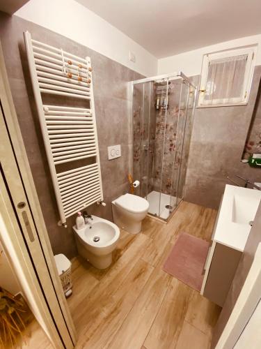 a bathroom with a shower and a toilet and a sink at Home Sweet Home in Foligno