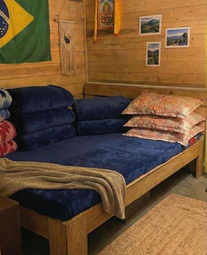 a bed with blue pillows on it in a room at Mandira Homestay in Jālāpahār