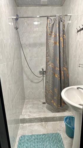 a bathroom with a shower and a sink at Dom Hostel in Samarkand