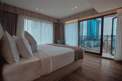 a bedroom with a bed with a view of a city at Coral Reef Kakkanad in Cochin