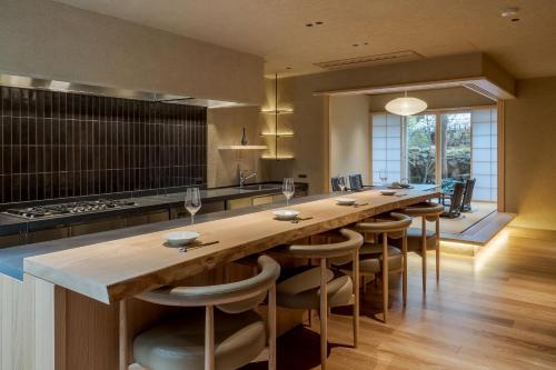 a large kitchen with a long table and chairs at 季楽 邸 清水 Kiraku Tei Kiyomizu in Kyoto