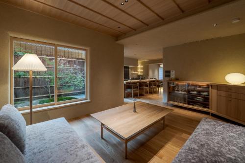 a living room with a couch and a coffee table at 季楽 邸 清水 Kiraku Tei Kiyomizu in Kyoto