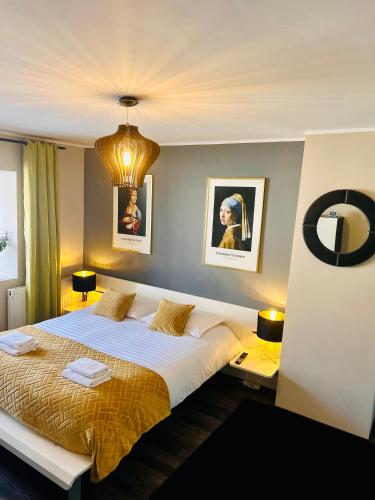 a bedroom with a large bed and two lamps at Zuzu’s home in Râşnov