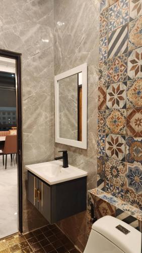 a bathroom with a sink and a mirror and a toilet at Pana Villa Koh Lanta in Ban Ai Dao