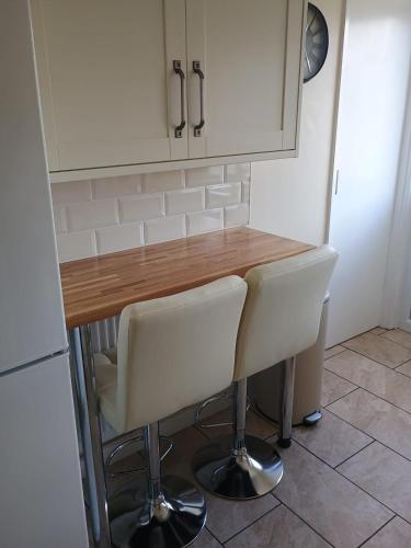 a kitchen with a table and two white chairs at Bideawee in Belton