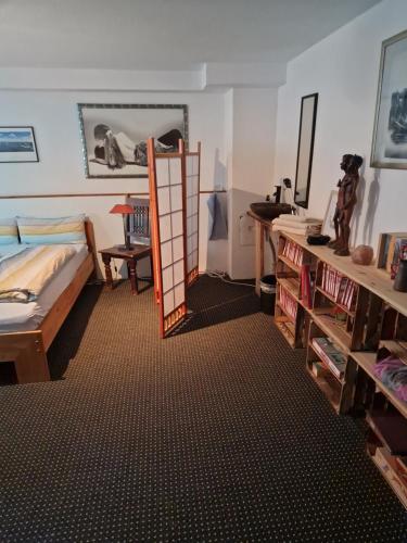 a bedroom with a bed and a ladder in a room at Großes gemütliches Zimmer mit eigener Dusche in Rheinstetten