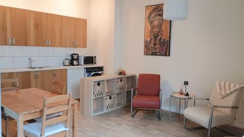 a kitchen with a table and a dining room at Guesthouse de Burght 2 - Bottendaal in Nijmegen