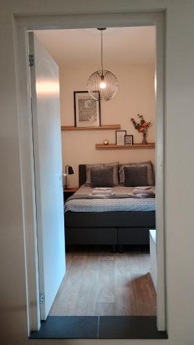 a bedroom with a bed and a large mirror at Guesthouse de Burght 2 - Bottendaal in Nijmegen