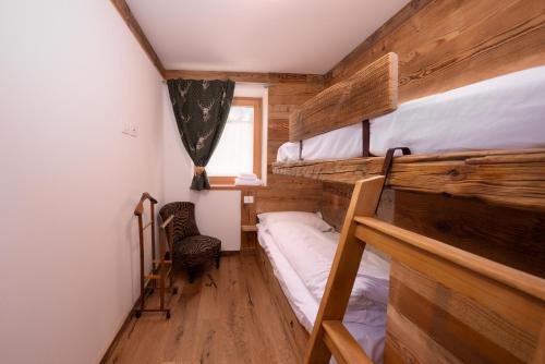 a small room with two bunk beds and a window at Arga' New Alpine Design Apartment Central & Scenic Views in San Vito di Cadore