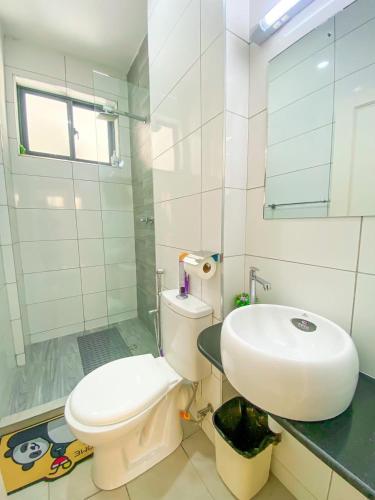 a bathroom with a white toilet and a sink at Nitro Homes Nyali-Coral Sands in Mombasa