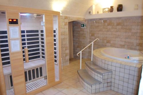 a bathroom with a tub and a walk in shower at Antica Mateola in Matera