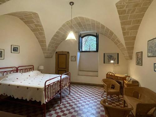 a bedroom with a bed and a table and chairs at Villa Del Prete in Nardò
