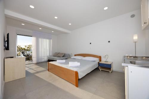 a bedroom with a bed and a living room at Apartments Klaricic in Živogošće