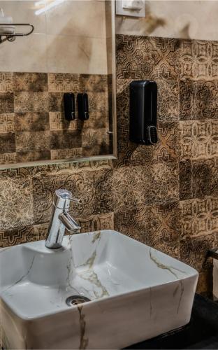a bathroom with a sink and a mirror at Sunoraa Luxury Hotel & Spa in Mussoorie