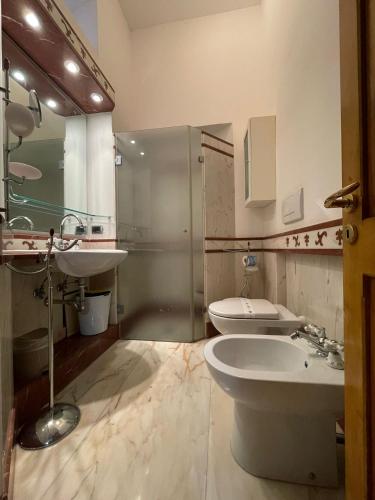 a bathroom with a sink and a toilet and a shower at Villa Del Prete in Nardò