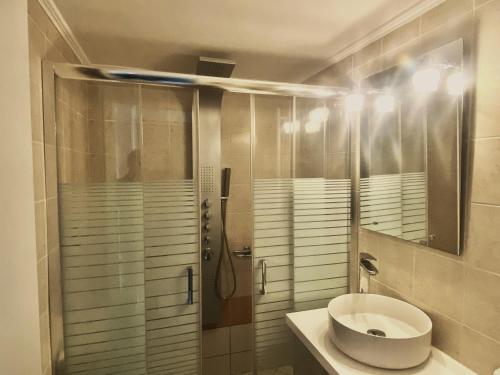a bathroom with a sink and a shower at Caviro in Moúdhros