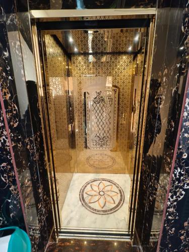a glass display case with a gold room with a stove at Mohar Residency Madhyamgram in kolkata