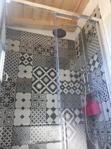 a bathroom with a shower with black and white tiles at Casa Andrean PT Lido Venezia in Venice-Lido