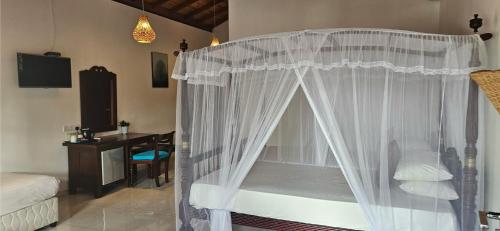 a bedroom with a canopy bed with white curtains at Surf Villa Hikkaduwa in Hikkaduwa