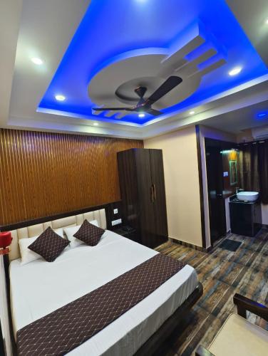 a bedroom with a bed with a blue ceiling at Mohar Residency Madhyamgram in kolkata