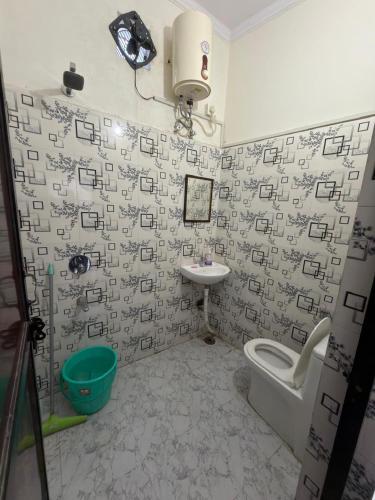a bathroom with a sink and a toilet and a sink at Bunk House in Rishīkesh