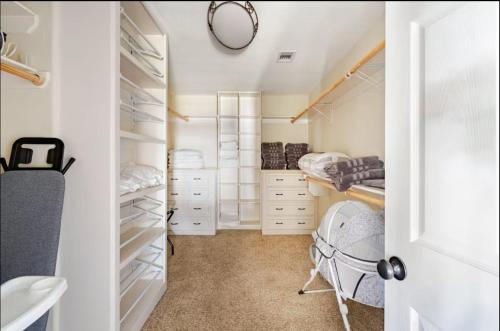 a bedroom with white cabinets and a walk in closet at Lucky House 2 Tranquility in the Middle of Houston in Houston