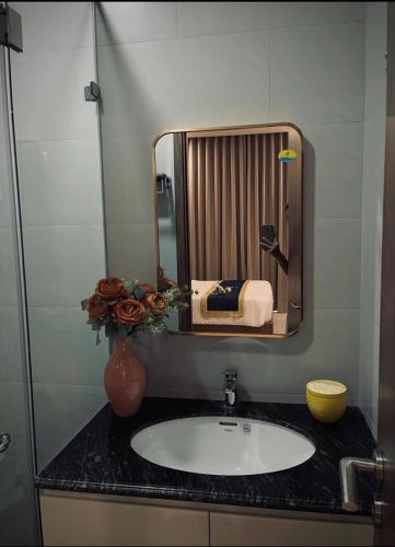 a bathroom with a sink and a mirror at Hotel Dell' Alba in Phú Quốc