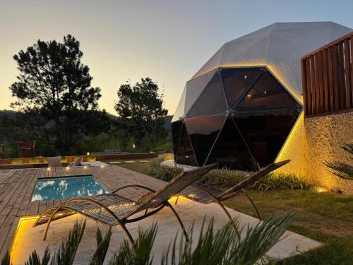 a house with a swimming pool and a building at Exclusive Cabanas BOLHA LUXO in Serra Negra