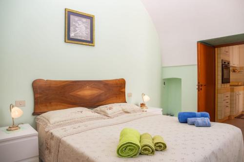 a bedroom with a bed with two towels on it at Casa Lucia in Specchia