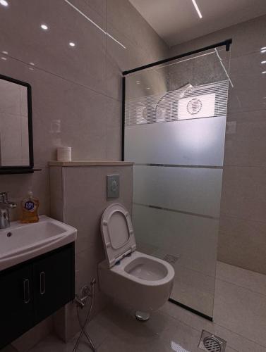 a bathroom with a toilet and a sink at شاليه الدرة Durra Chalet in Amman