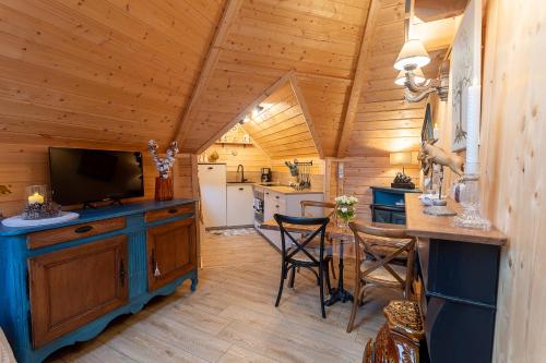 a kitchen with a television and a counter with chairs at Lodge Mon Petit Lapin in Montgon