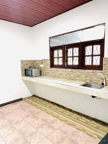 a kitchen with a sink and a window at S70 Villa in Dickwella