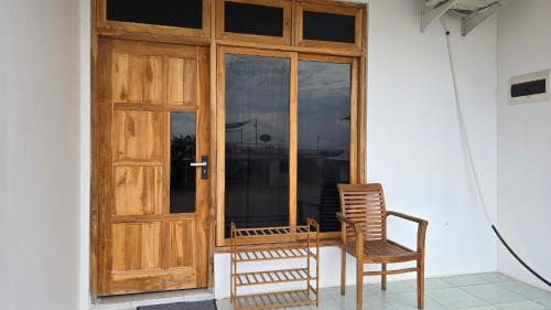 a pair of chairs sitting in front of a door at Apartamentos de Metiaut in Dili