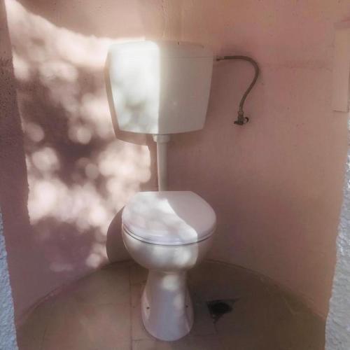 a bathroom with a white toilet in a room at Barreira beachfront Tents 9 in Verga Kalamata
