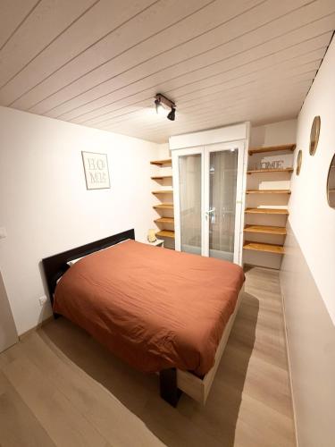 a bedroom with a bed in a room with stairs at L' Escapade Pannessac premier étage in Le Puy-en-Velay