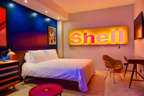 a hotel room with a bed with a shell sign on the wall at Boutique Hotel Trieste - Adults Only in Verona