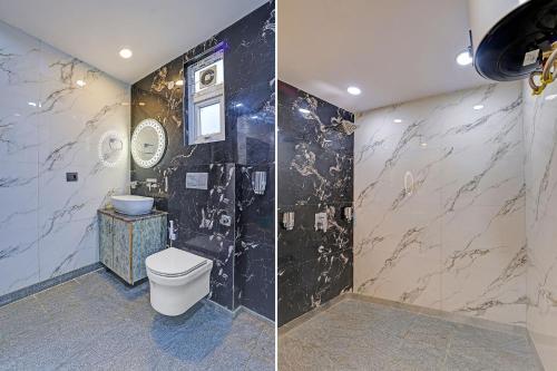 a bathroom with a toilet and a marble wall at FabHotel Havenora - Nr Maharani Bagh in New Delhi