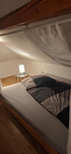 a bed in a bedroom next to a table at Fewo Jura Hills in Pommelsbrunn